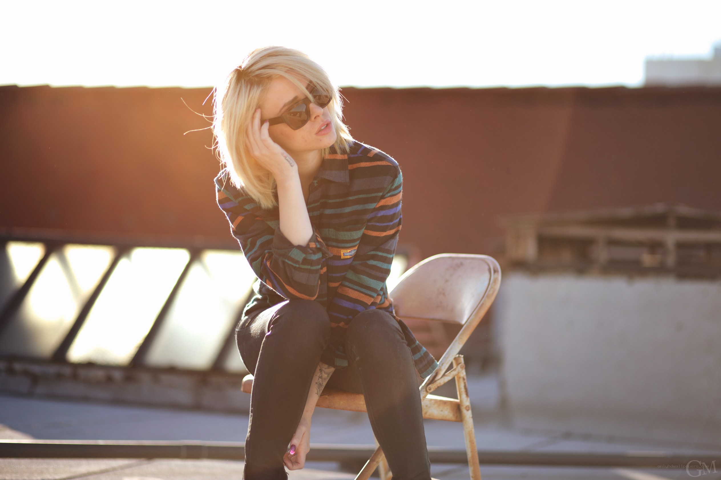 woman sitting on chair at sunset