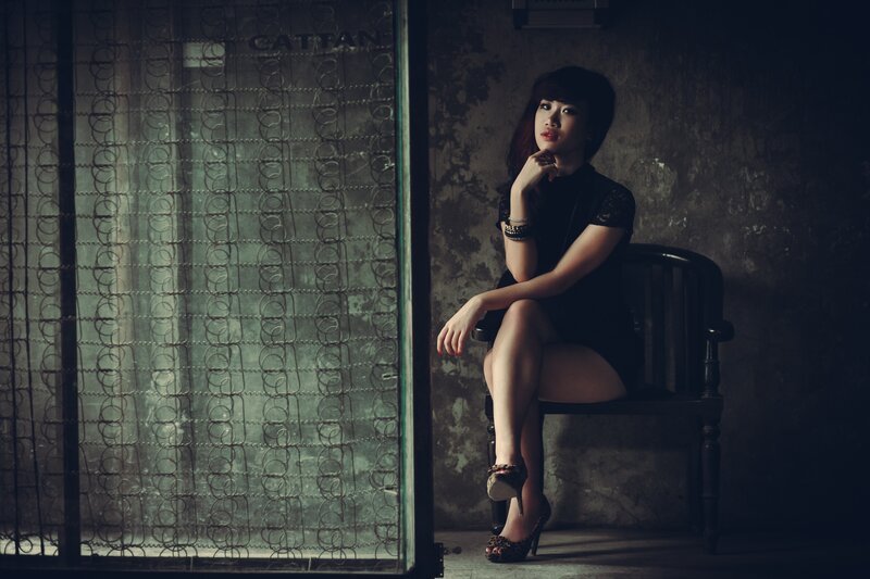 Woman Sitting on Chair — Black, Dramatic, Night, Photograph, Wall
