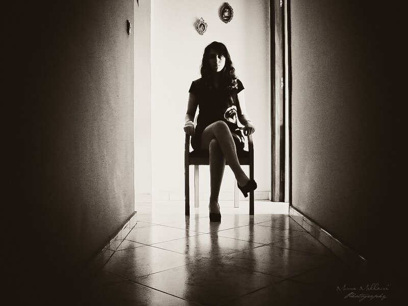 Woman Sitting on Chair — Black, Dramatic, Photograph, Wall, Floor