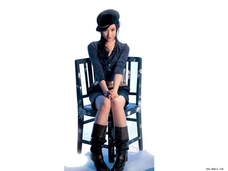 Woman Sitting on Chair — Black, Neutral, Photograph, Hat