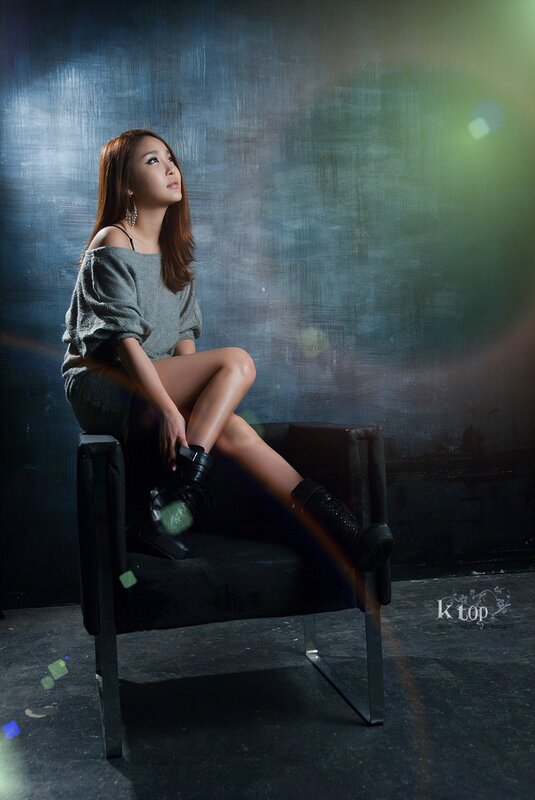 woman sitting on chair in studio