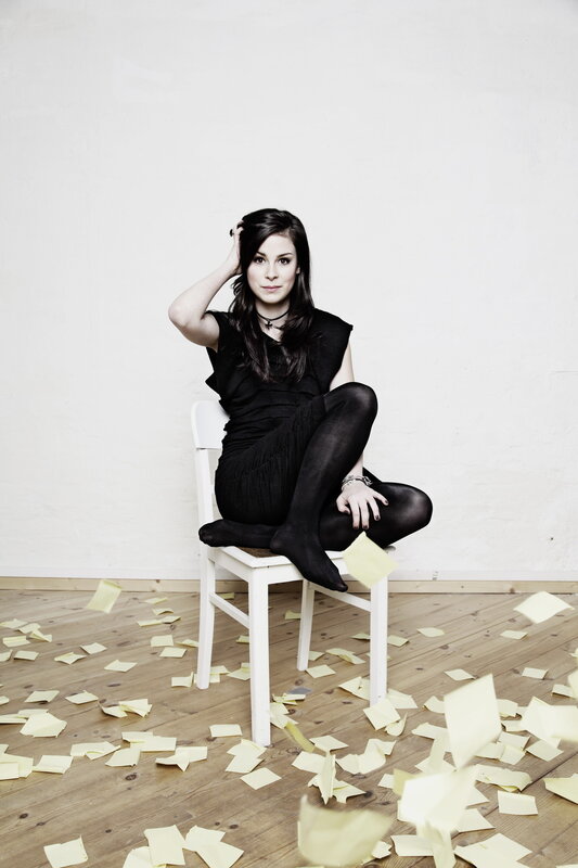 woman sitting on chair with notes