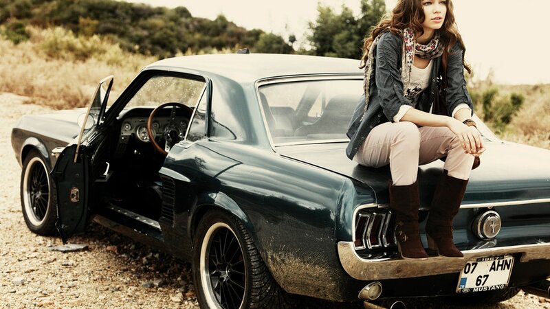 woman sitting on classic car
