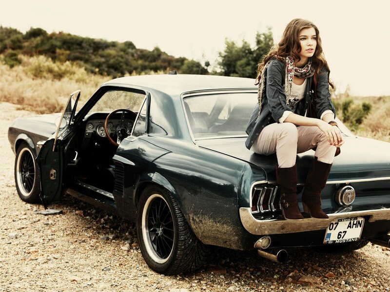 woman sitting on classic car
