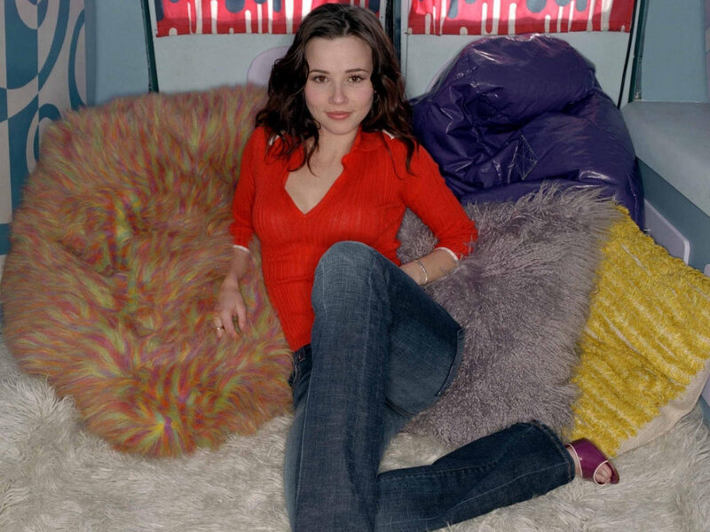 woman sitting on colorful pillows