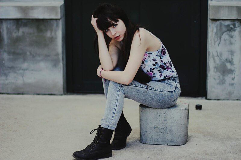 woman sitting on concrete block