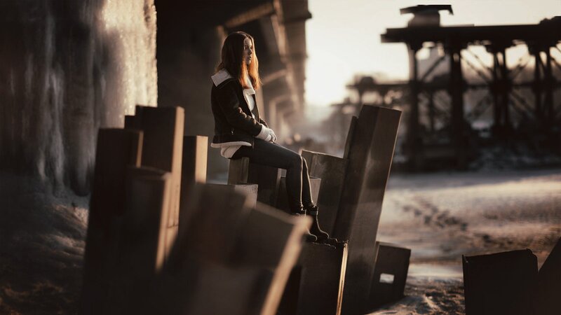 woman sitting on concrete blocks