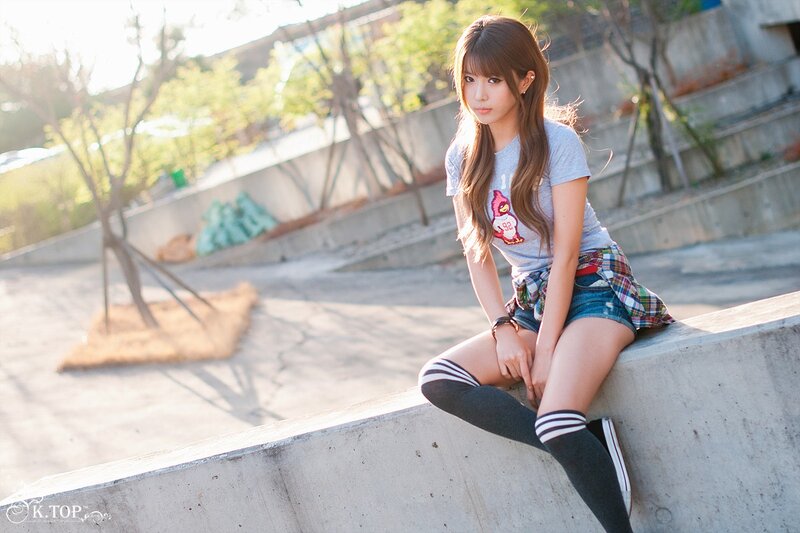 woman sitting on concrete ledge