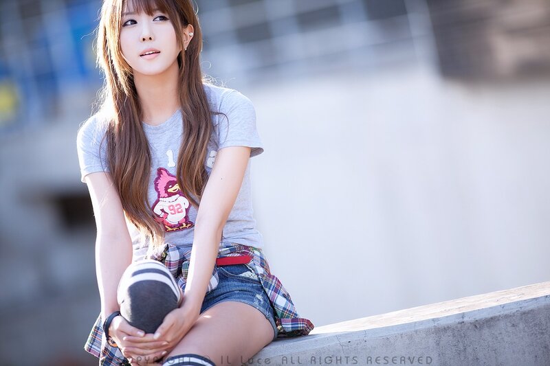 woman sitting on concrete ledge
