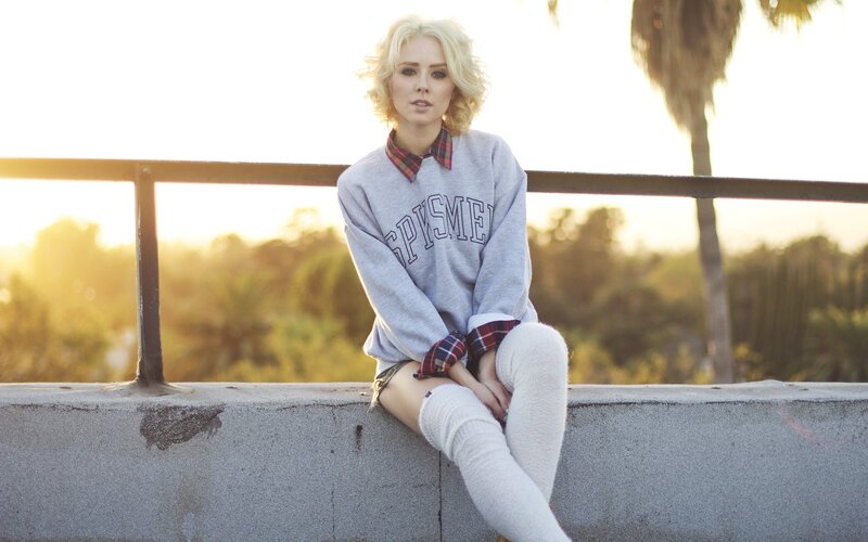 woman sitting on concrete ledge