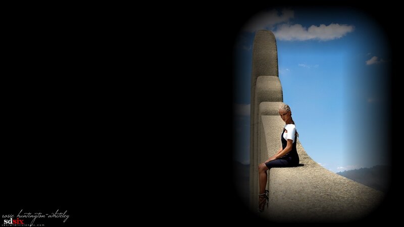 woman sitting on concrete structure