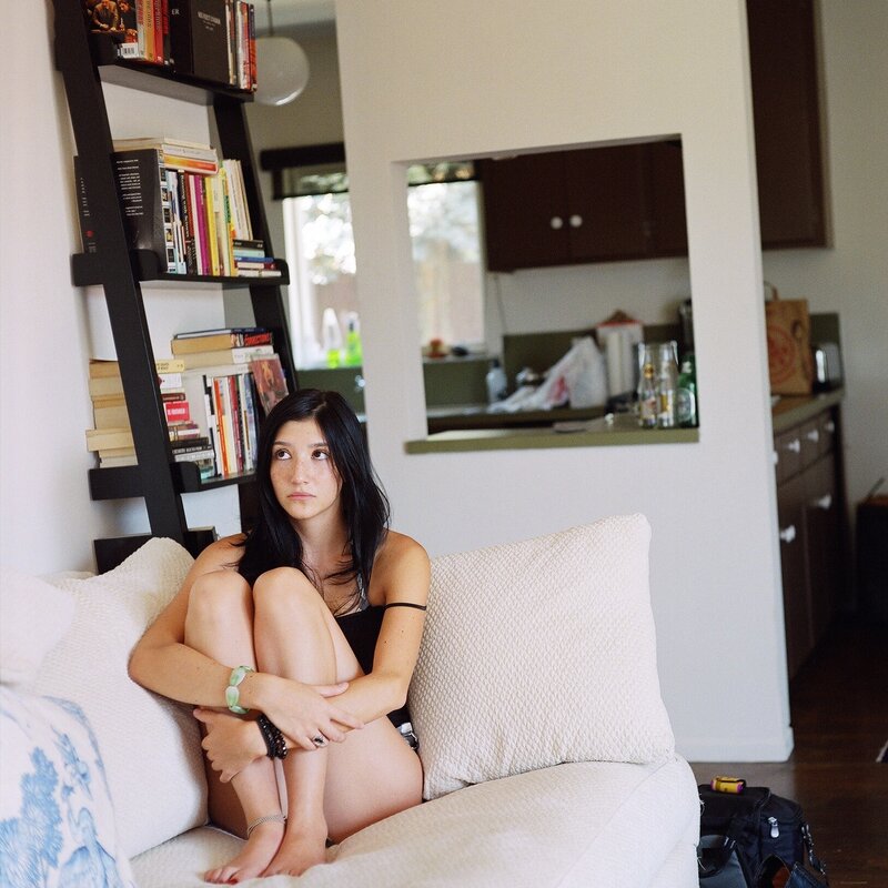 woman sitting on couch at home