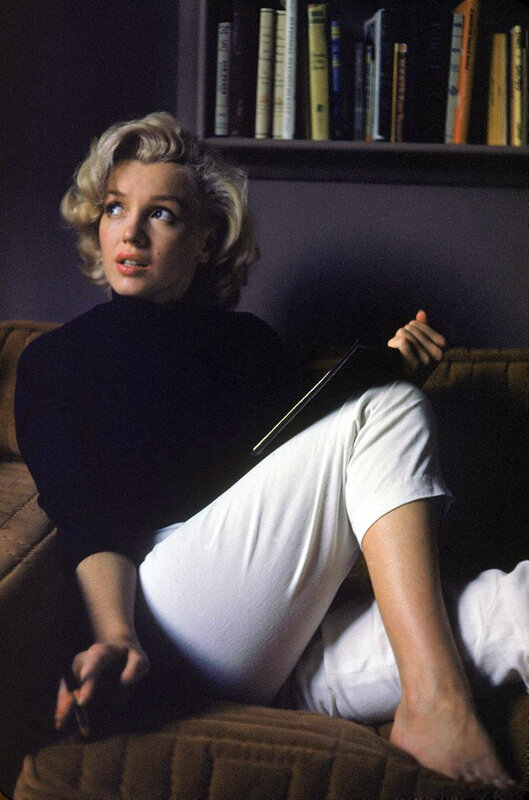 Woman Sitting on Couch — Black, Relaxed, Photograph, Bookshelf
