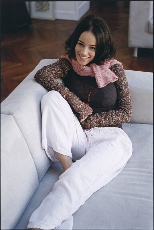 Woman Sitting on Couch — White, Relaxed, Photograph, Scarf