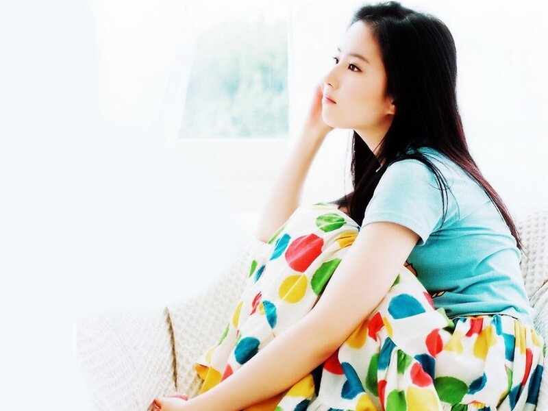 woman sitting on couch with blanket