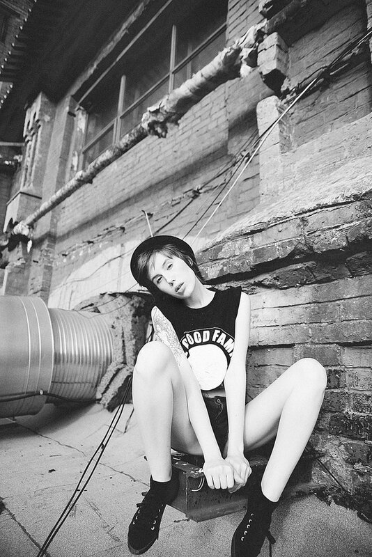 Woman Sitting on Crate — Black, Gritty