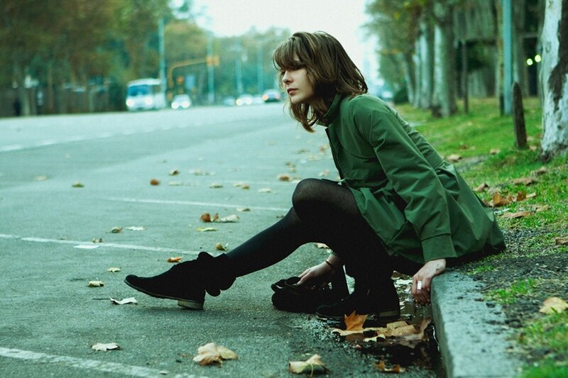 woman sitting on curb