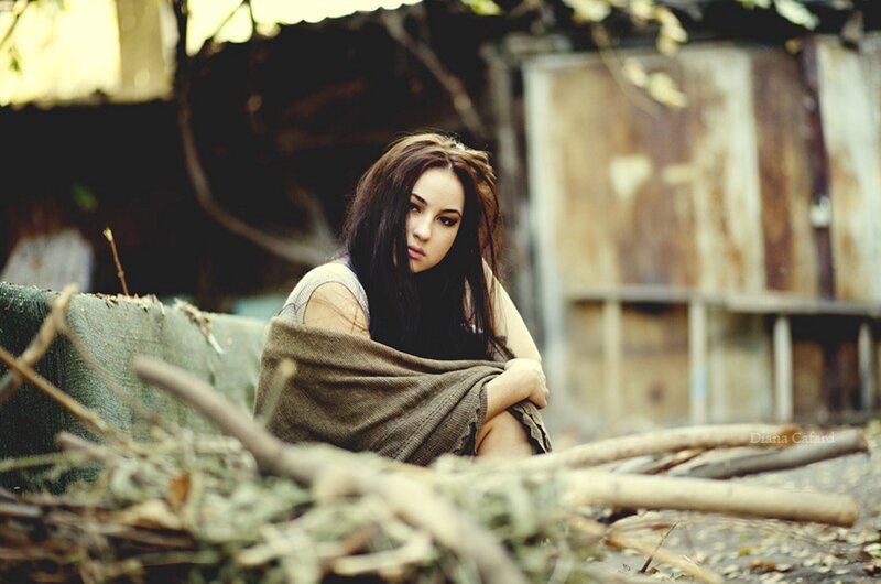 Woman Sitting on Debris — Brown