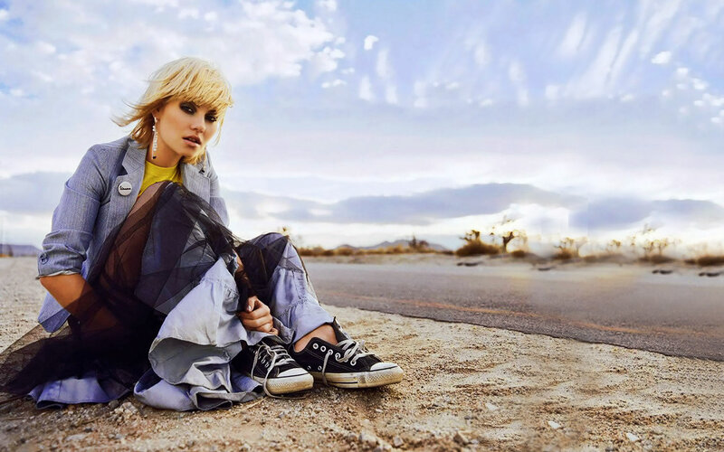 woman sitting on desert road