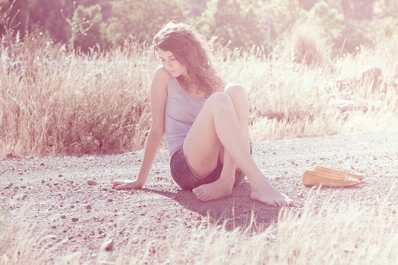 Woman Sitting on Dirt Path