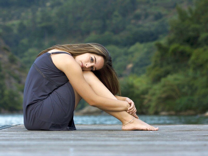 woman sitting on dock