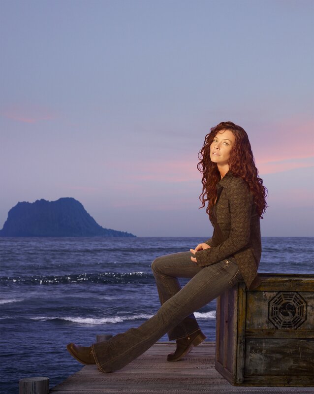 woman sitting on dock at sunset