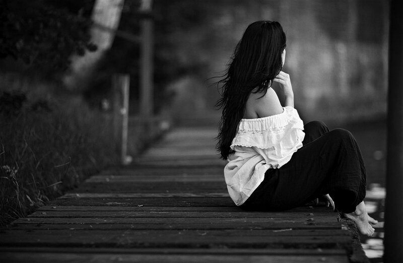 Woman Sitting on Dock — Black, Contemplative