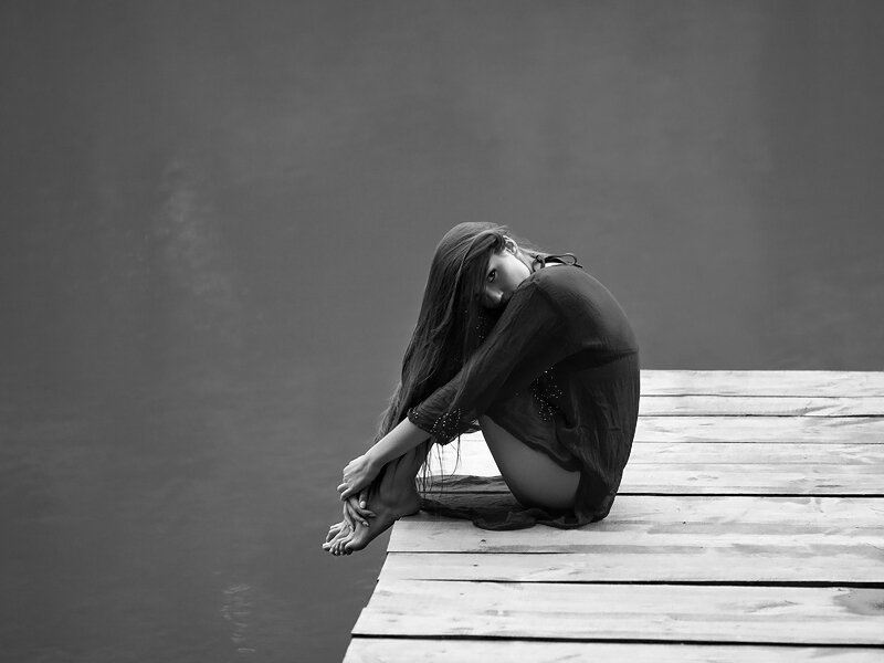 Woman Sitting on Dock — Black, Melancholic