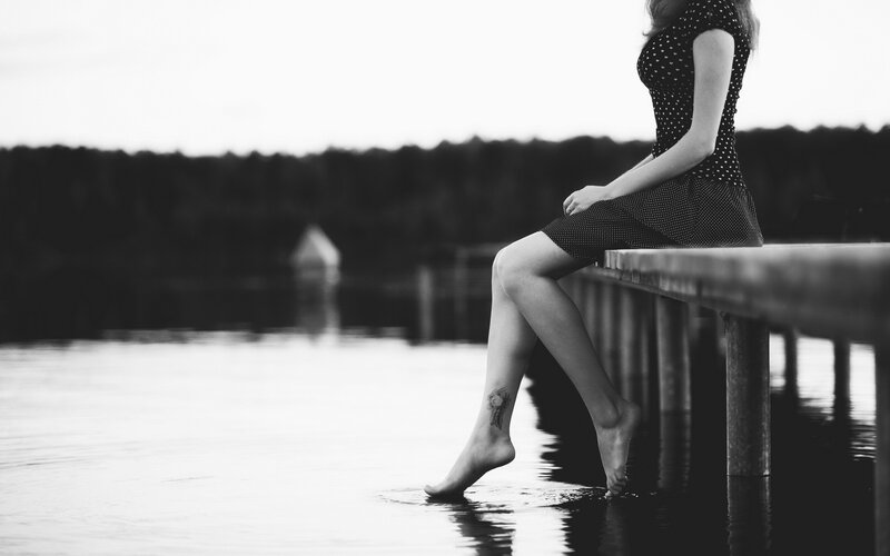 Woman Sitting on Dock — Black, Serene, Sunset, Photograph, Dress