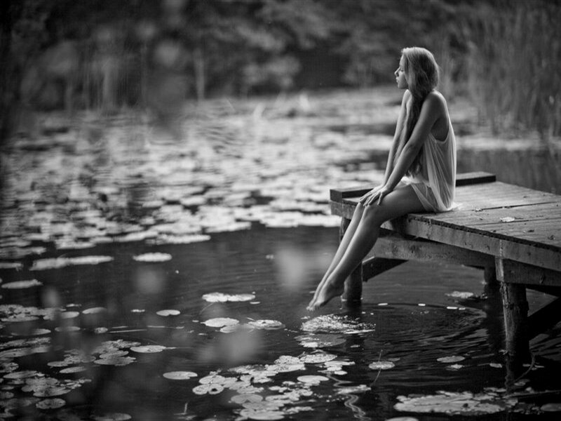 Woman Sitting on Dock — Black, Serene