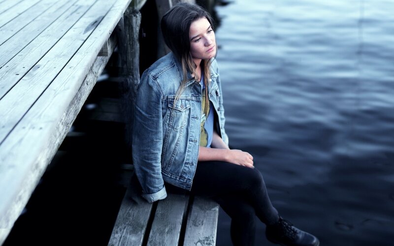 Woman Sitting on Dock — Blue, Contemplative