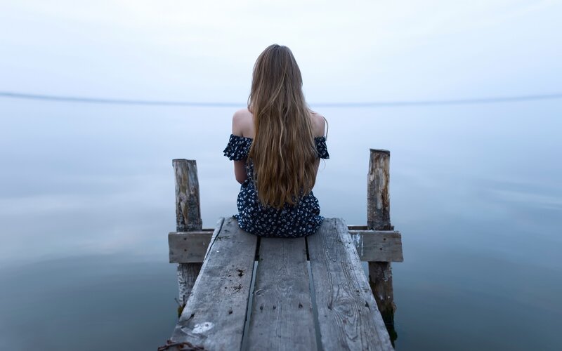 Woman Sitting on Dock — Blue, Serene