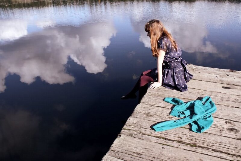 Woman Sitting on Dock — Blue