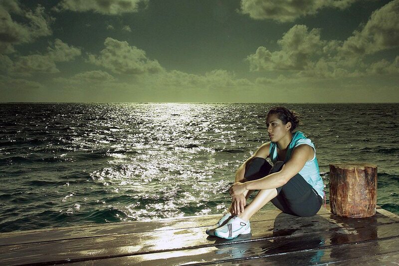 Woman Sitting on Dock — Green, Dramatic
