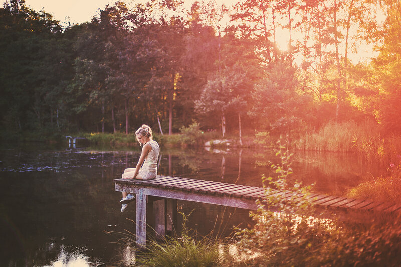 Woman Sitting on Dock — Orange