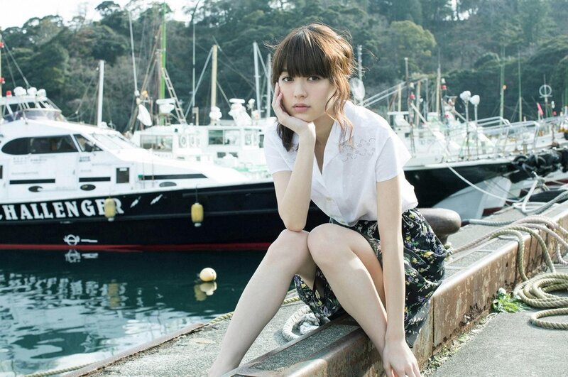 Woman Sitting on Dock — White, Calm, Afternoon, Photograph, Boat, Trees