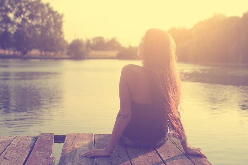 Woman Sitting on Dock — Yellow