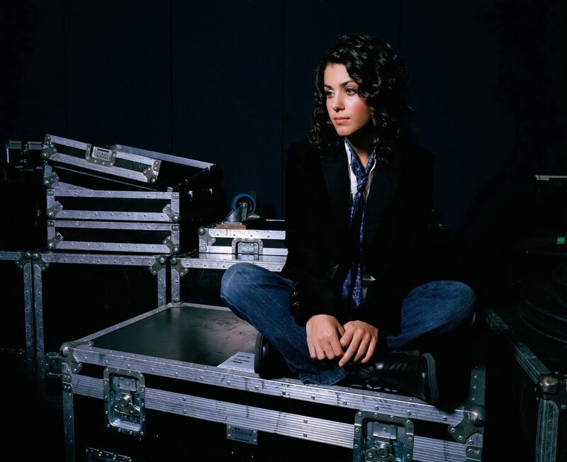 woman sitting on equipment case