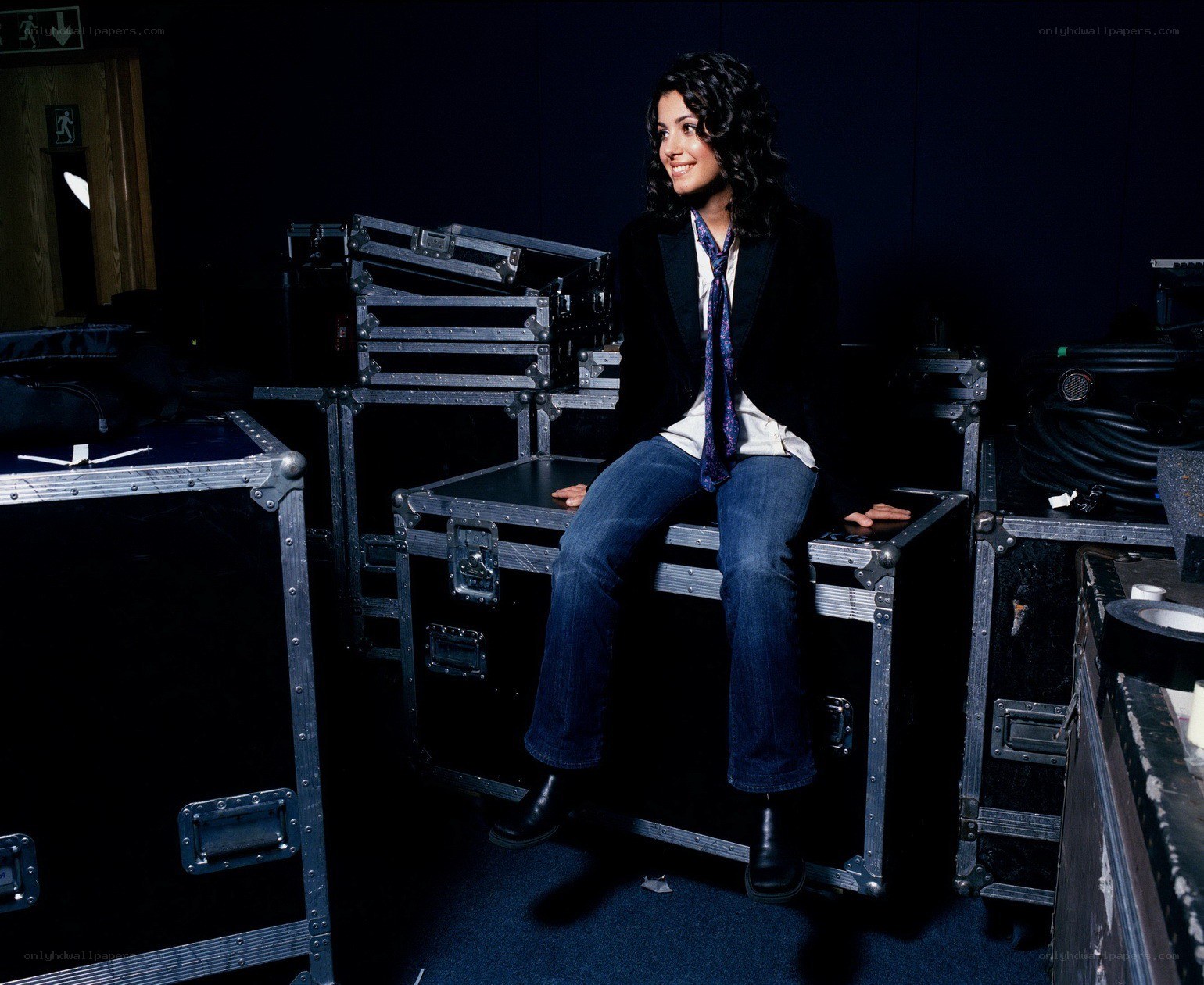 woman sitting on equipment cases
