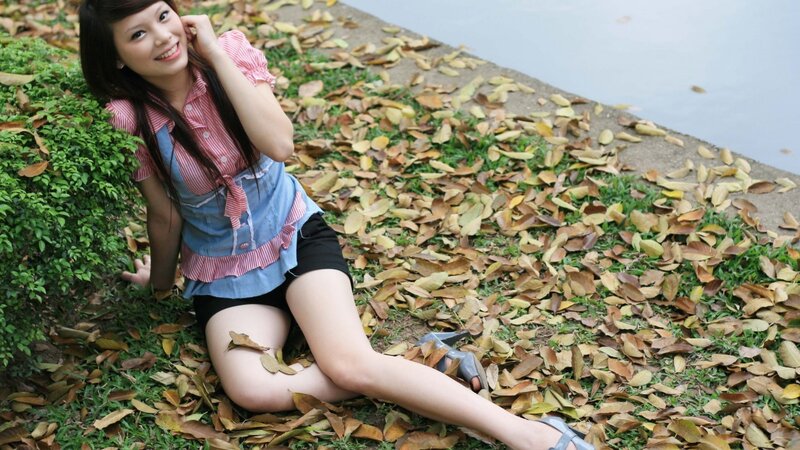 woman sitting on fallen leaves