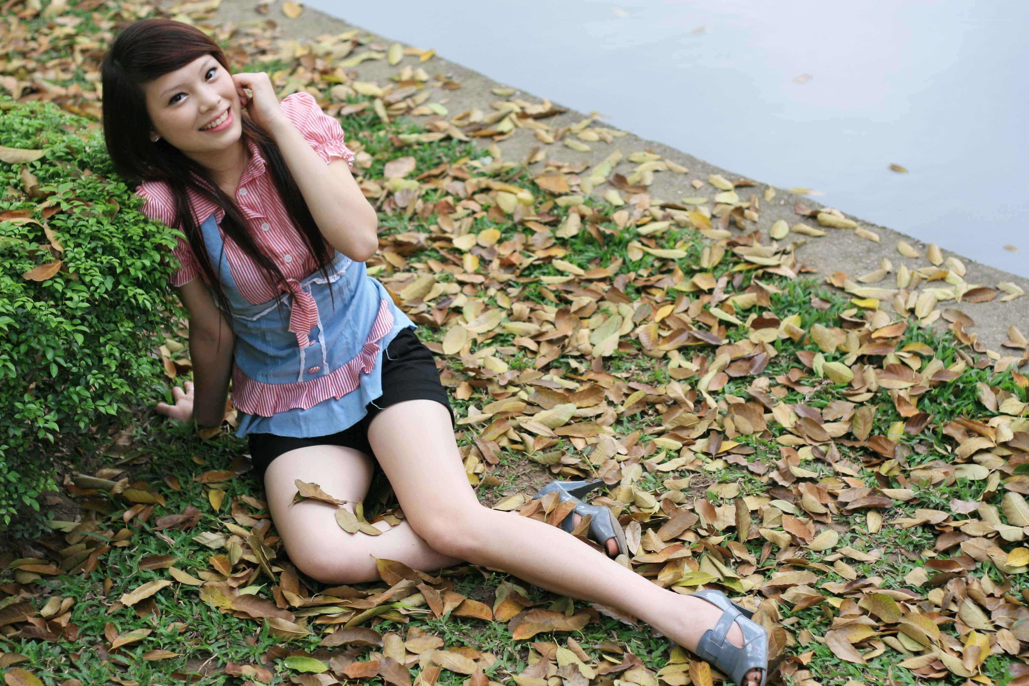 woman sitting on fallen leaves