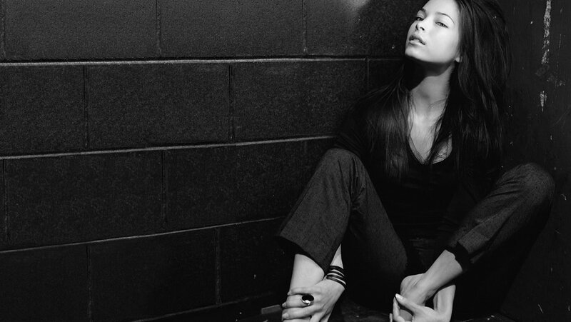 Woman Sitting on Floor — Black, Dramatic, Photograph, Wall, Pants