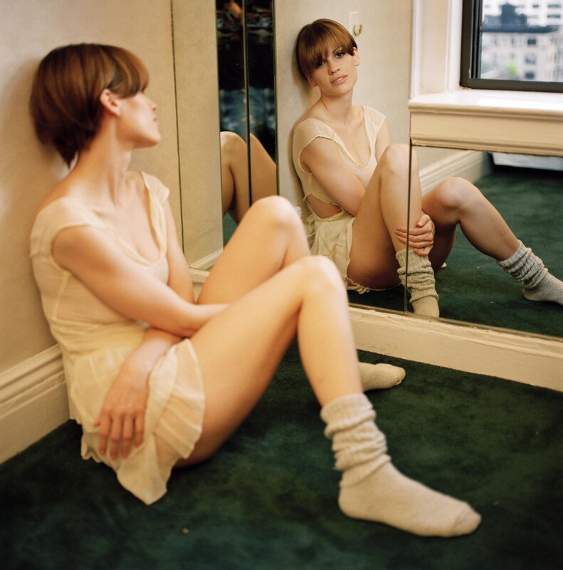 woman sitting on floor by mirror