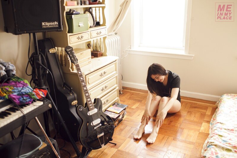 woman sitting on floor in bedroom