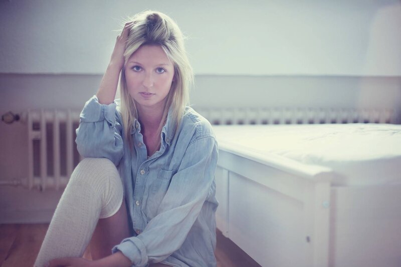 woman sitting on floor in bedroom