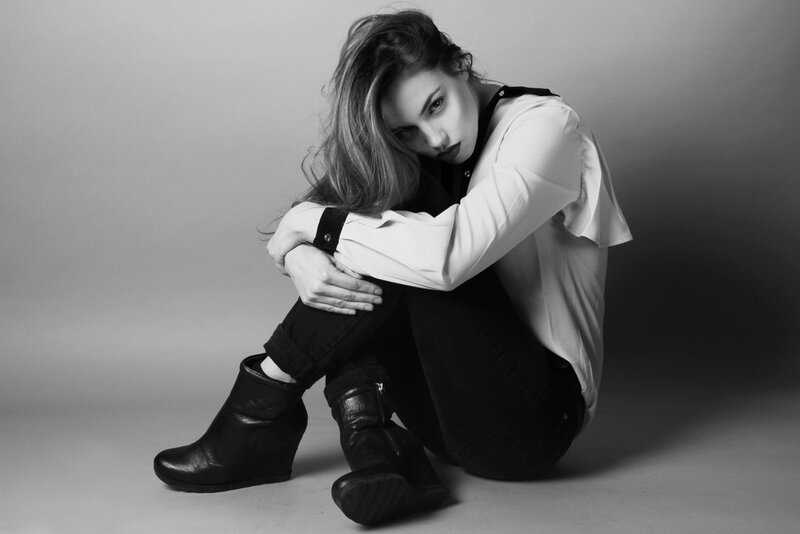woman sitting on floor in black and white