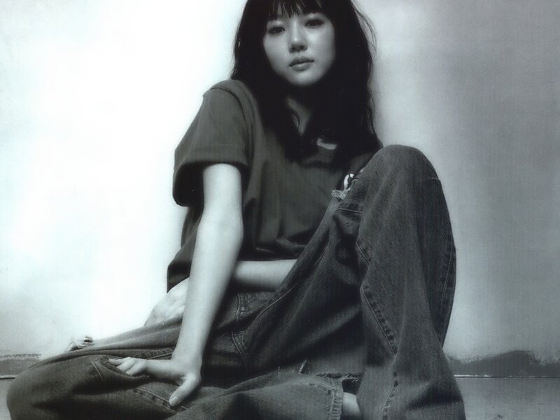 woman sitting on floor in black and white