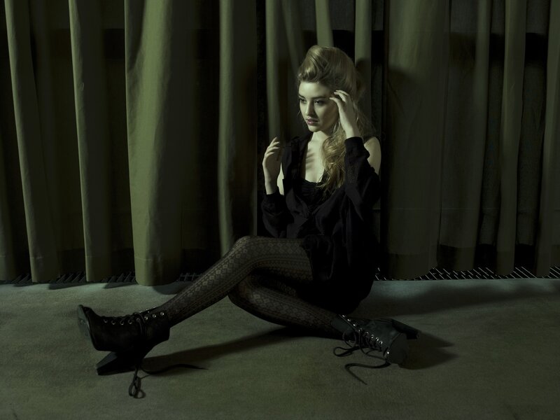 woman sitting on floor in dark room