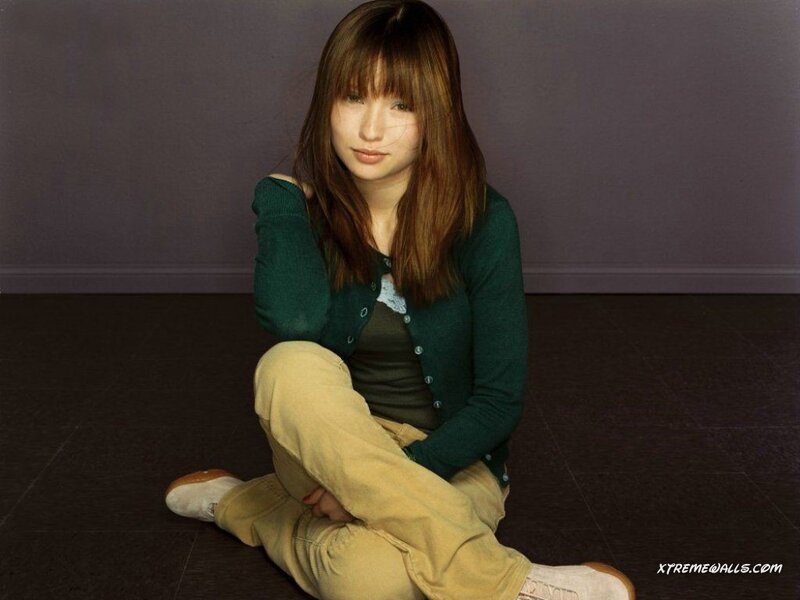 woman sitting on floor in green cardigan