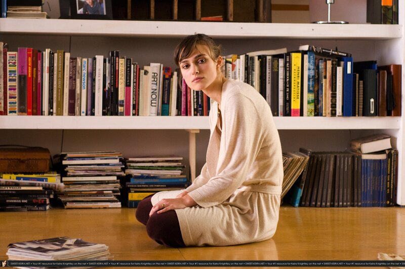 woman sitting on floor in library